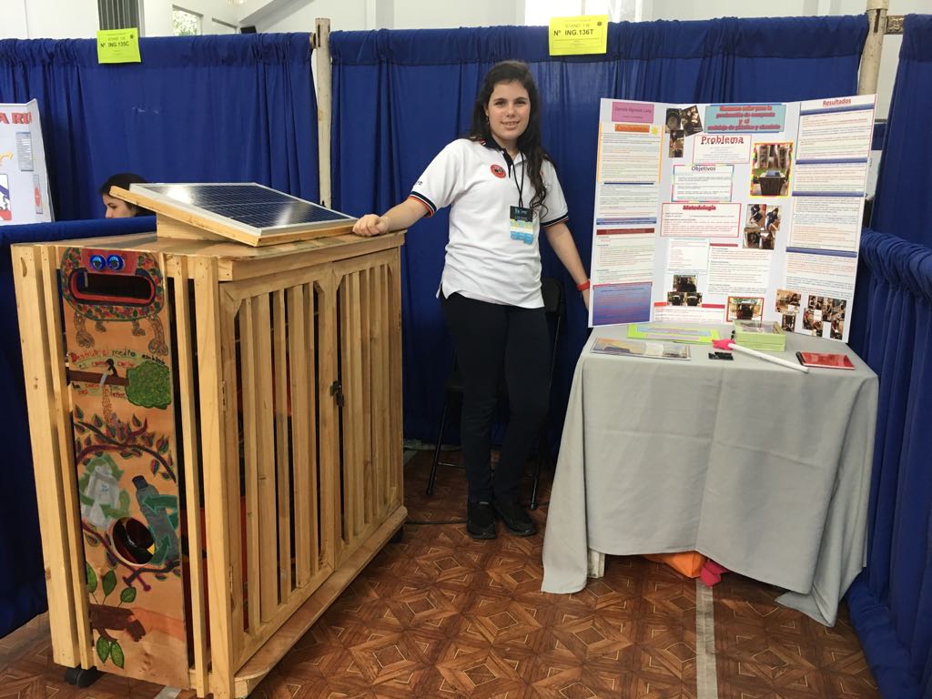 Daniela beside the first wooden Compocycler build and its poster at the Costa Rica National Science Fair