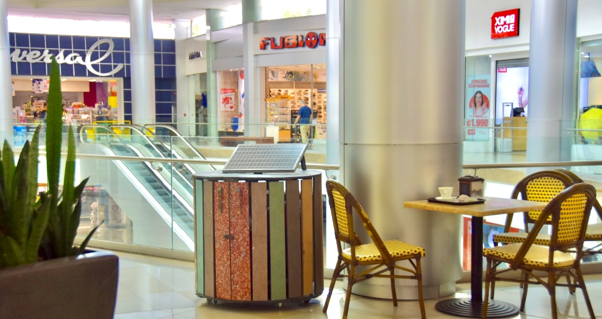 The Compocycler installed in a shopping centre in Costa Rica, solar panel on top, beside cafe seating