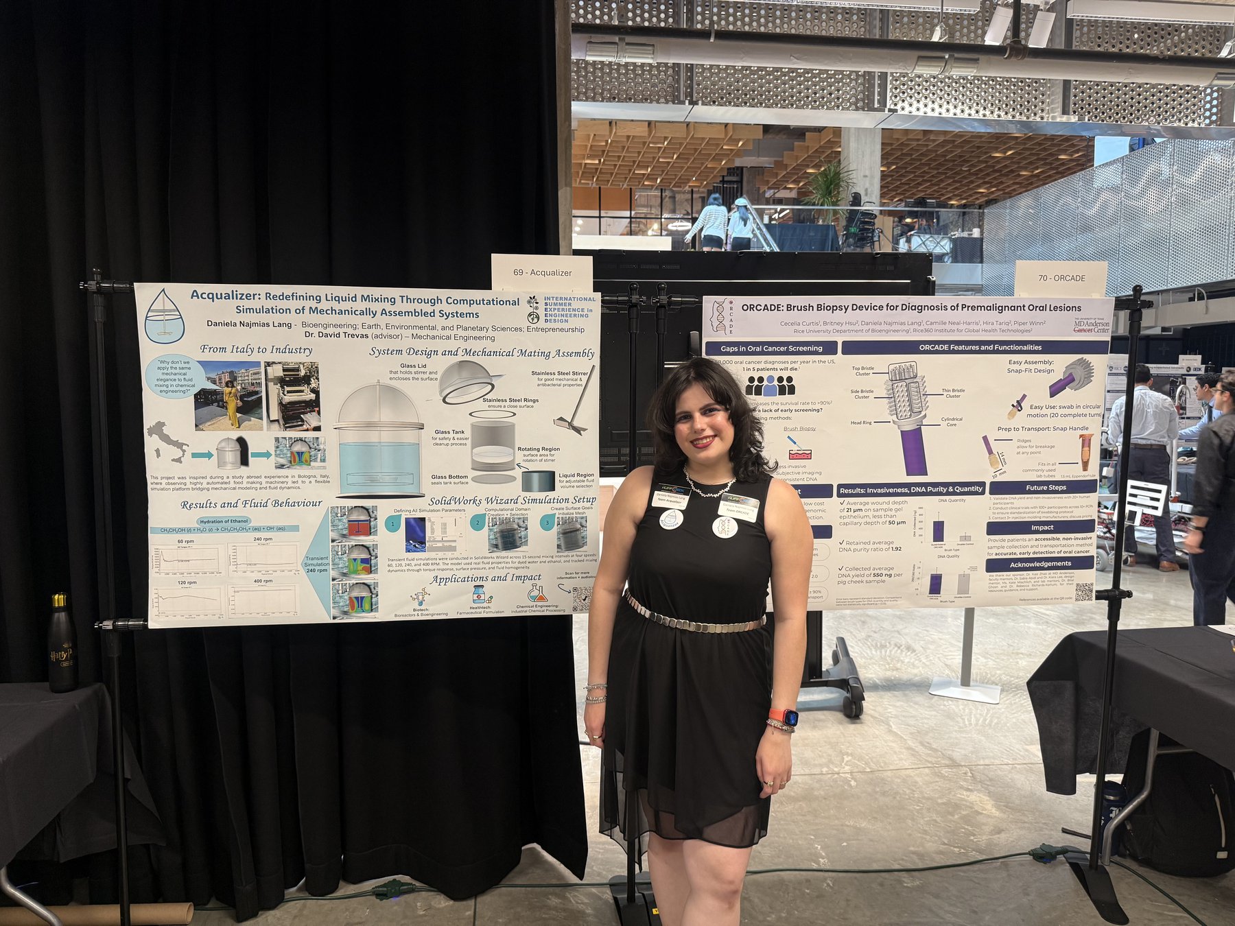 Daniela Najmias Lang standing between two research posters at the Rice Engineering Design Showcase: Acqualizer on the left and ORCADE on the right